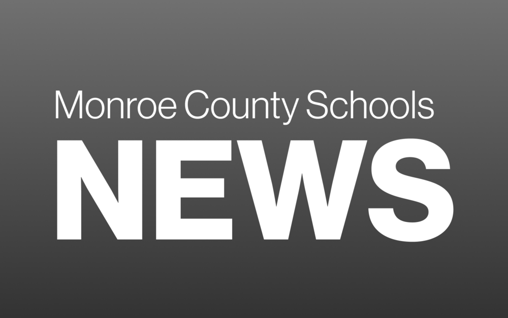 Gray graphic with white writing that says monroe county schools news
