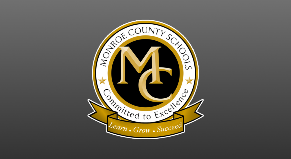 monroe county schools logo with grey background